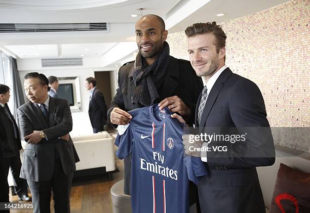 David Beckham presents a jersey to Frederic Kanoute of Beijing Guo'an at Workers Stadium on March 21, 2013 in Beijing, China.