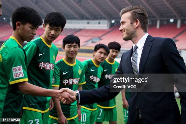 David Beckham shakes hands with players at Beijing Guo'an Football Club at Workers Stadium on March 21, 2013 in Beijing, China.