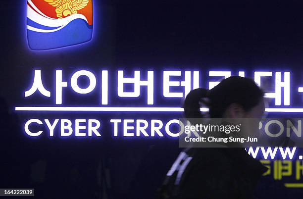 South Korean police officer from Digital Forensic Investigation walks past at Cyber Terror Response Center at National Police Agency on March 21,...