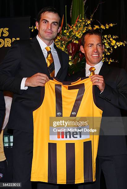 Hawks coach Alastair Clarkson presents Brian Lake his jumper on stage during the Hawthorn Hawks Season Launch and Hall of Fame presentation at Encore...