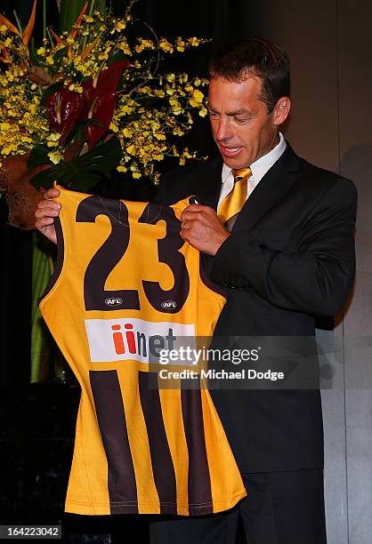 Hawks coach Alastair Clarkson looks at the jumper of Lance Franklin on stage during the Hawthorn Hawks Season Launch and Hall of Fame presentation at...