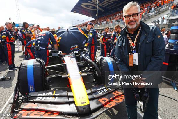 Steve Carell poses for a photo with the car of Max Verstappen of the Netherlands and Oracle Red Bull Racing on the grid prior to the F1 Grand Prix of...