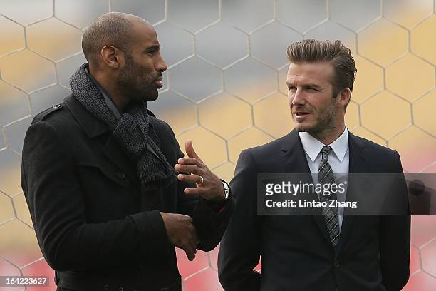 Frederic Kanoute of Beijing Guo'an with British football player David Beckham during his visits Beijing Guo'an Football Club at Workers Stadium on...