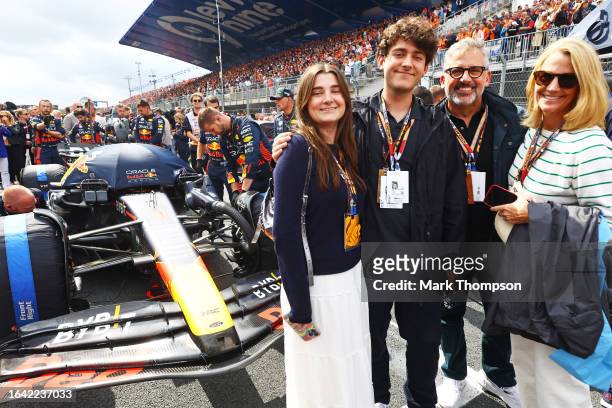 Steve Carell, Nancy Carell, Annie Carell and Johnny Carell pose for a photo with the car of Max Verstappen of the Netherlands and Oracle Red Bull...