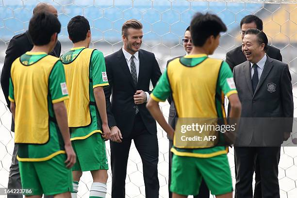 Football superstar David Beckham chats with players during a visit to Beijing Guoan soccer club in Beijing on March 21, 2013. Beckham flew to Beijing...