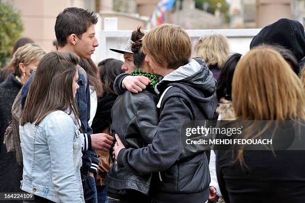 Students grieve on March 21, 2013 in front of l'Estuaire technical college in Blaye, south-western France, after the announcement that a fellow...