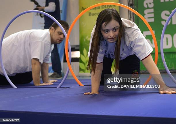 Young people with Down Syndrome take part in a contest during an event marking the International Day of Down Syndrome in Bucharest March 21, 2013....