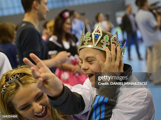 Child with Down Syndrome wearing a crown is pictured during an event marking the International Day of Down Syndrome in Bucharest March 21, 2013....