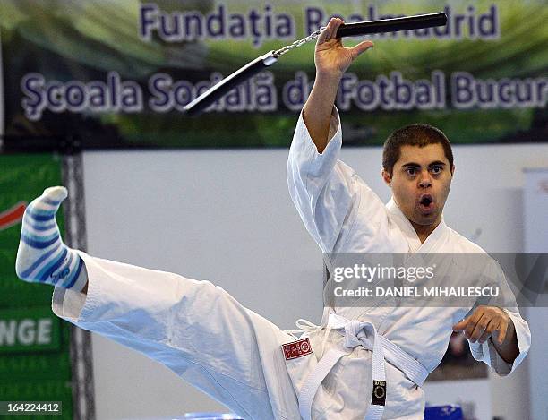 Young man with Down Syndrome performs during an event marking the International Day of Down Syndrome in Bucharest March 21, 2013. March 21 aims to...