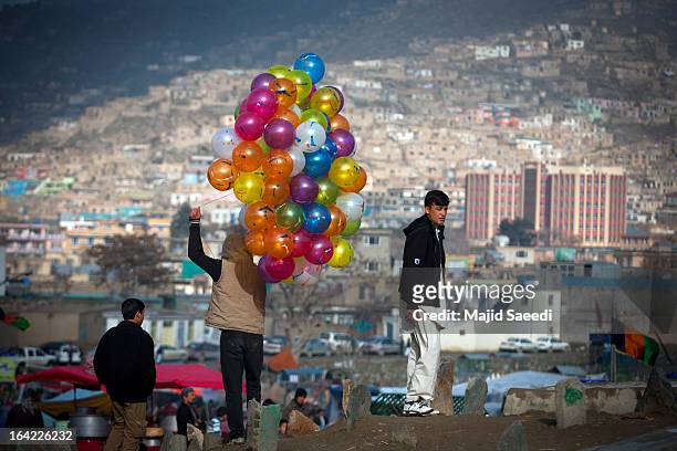 An Afghan vendor sells balloons near the Sakhi shrine, which is the centre of the Afghanistan new year celebrations during the Nowruz festivities on...