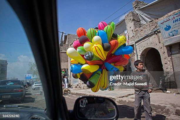 Young Afghan vendor sells balloons near the Sakhi shrine, which is the centre of the Afghanistan new year celebrations during the Nowruz festivities...