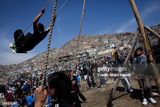 An Afghan boy plays on a swing near the Sakhi shrine, which is the centre of the Afghanistan new year celebrations during the Nowruz festivities on...