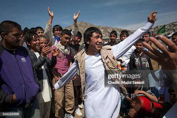 Afghan boys dance during a celebrations near the Sakhi shrine, which is the centre of the Afghanistan new year celebrations during the Nowruz...