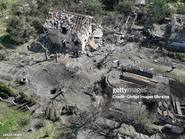 An aerial view of a missile crater and private houses damaged by a missile explosion on August 27, 2023 in Kyiv Oblast, Ukraine. At night, Russian...