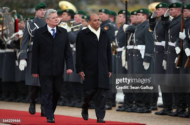 German President Joachim Gauck and Tunisian President Moncef Marzouki review a gaud of honour upon Marzouki's arrival at Bellevue Palace on March 21,...