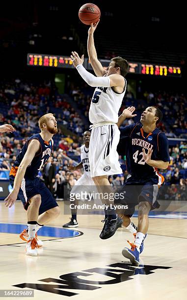 Rotnei Clarke of the Butler Bulldogs shoots against Joe Willman and Cameron Ayers of the Bucknell Bison in the first half during the second round of...