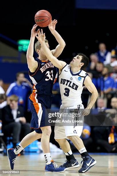 Ben Brackney of the Bucknell Bison passes against Alex Barlow of the Butler Bulldogs in the first half during the second round of the 2013 NCAA Men's...