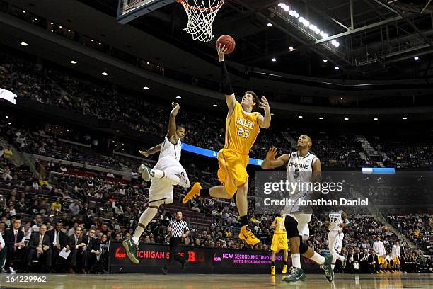 Matt Kenney of the Valparaiso Crusaders drives for a shot attempt in the first half against Adreian Payne of the Michigan State Spartans during the...