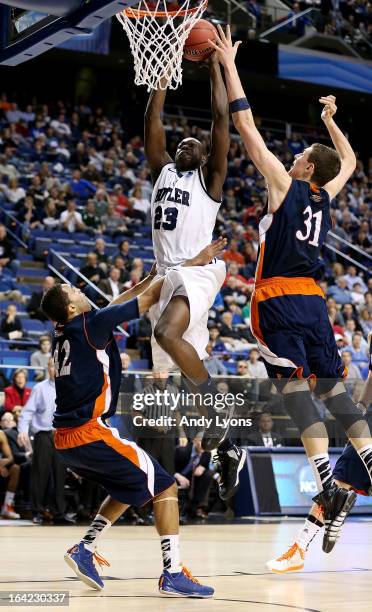 Khyle Marshall of the Butler Bulldogs shoots against Cameron Ayers and Mike Muscala of the Bucknell Bison in the first half during the second round...