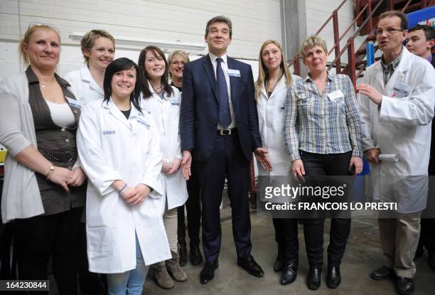 French Minister for Industrial Renewal Arnaud Montebourg poses with Sealock employees during his visit to the plant of industrial glue manufacturer...