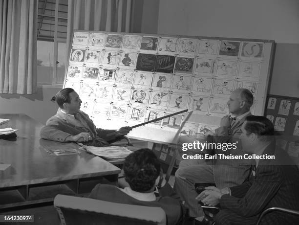 Walt Disney points to a storyboard for the commisioned animated short 'Hookworm' circa 1945 in Los Angeles, California.