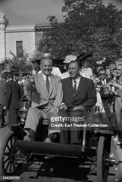 Walt Disney and California Governor Goodwin Knight ride an early Pierce-Arrow on the opening day of Disneyland on July 15, 1955 in Anaheim,...