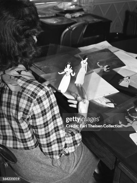 Disney animator works on cells from the film 'Snow White' circa 1936 in Los Angeles, California.