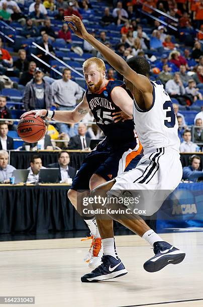 Joe Willman of the Bucknell Bison drives against Kameron Woods of the Butler Bulldogs in the first half during the second round of the 2013 NCAA...