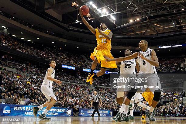 Erik Buggs of the Valparaiso Crusaders drives for a shot attempt against Adreian Payne of the Michigan State Spartans during the second round of the...