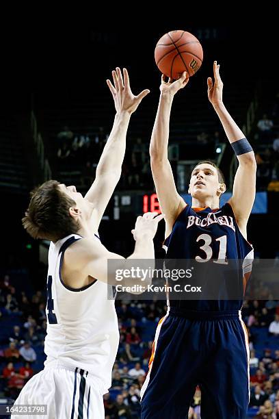 Mike Muscala of the Bucknell Bison shoots against Andrew Smith of the Butler Bulldogs in the first half during the second round of the 2013 NCAA...