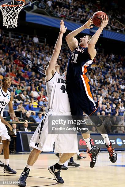 Mike Muscala of the Bucknell Bison shoots against Andrew Smith of the Butler Bulldogs in the second half during the second round of the 2013 NCAA...