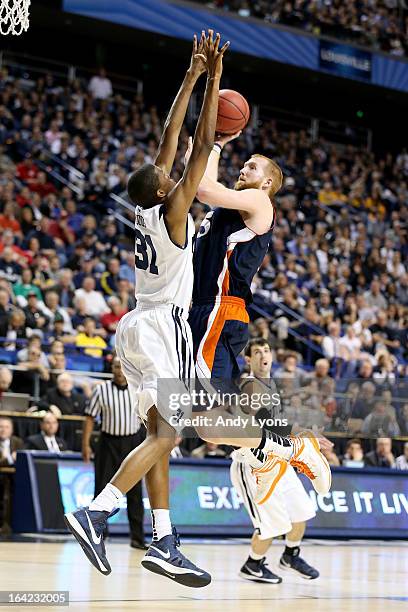 Joe Willman of the Bucknell Bison shoots against Kameron Woods of the Butler Bulldogs in the second half during the second round of the 2013 NCAA...