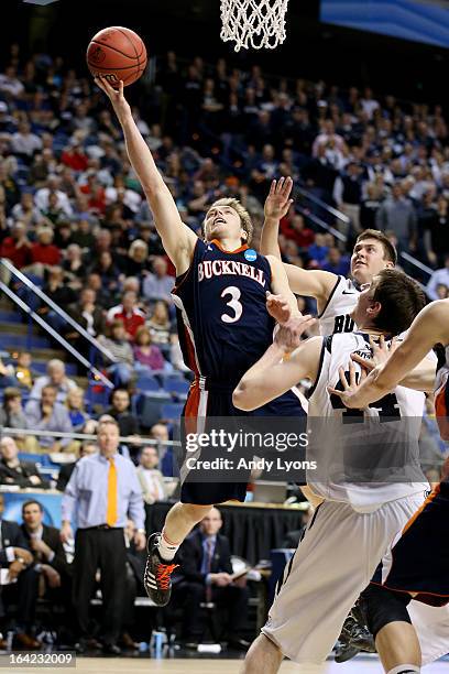 Steven Kaspar of the Bucknell Bison shoots against Andrew Smith of the Butler Bulldogs in the second half during the second round of the 2013 NCAA...