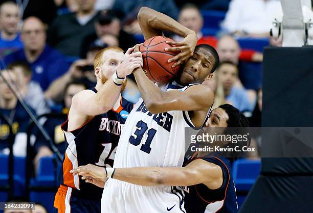 Kameron Woods of the Butler Bulldogs is fouled by Joe Willman and Bryson Johnson of the Bucknell Bison in the second half during the second round of...