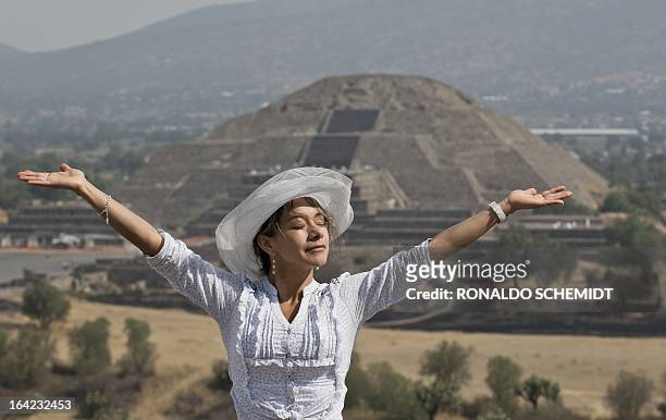 Woman "gets energy" from the sun atop the Pyramid of the Sun at the archaeological site of Teotihuacan, Mexico, during the celebrations for the...