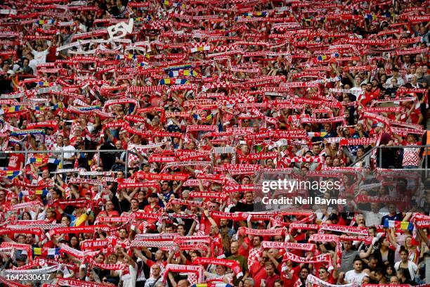 Mainz 05 fans hold scarves ahead of the Bundesliga match between 1. FSV Mainz 05 and Eintracht Frankfurt at MEWA Arena on August 27, 2023 in Mainz,...