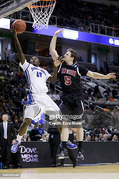 Mike McCall Jr. #11 of the Saint Louis Billikens shoots against Kevin Aronis of the New Mexico State Aggies in the second half during the second...