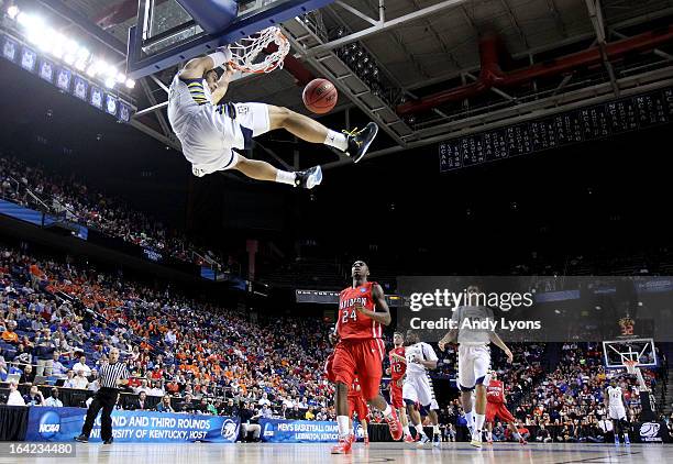 Trent Lockett of the Marquette Golden Eagles slam dunks against the Davidson Wildcats in the first half during the second round of the 2013 NCAA...