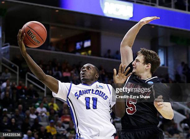 Mike McCall Jr. #11 of the Saint Louis Billikens shoots against Kevin Aronis of the New Mexico State Aggies in the second half during the second...