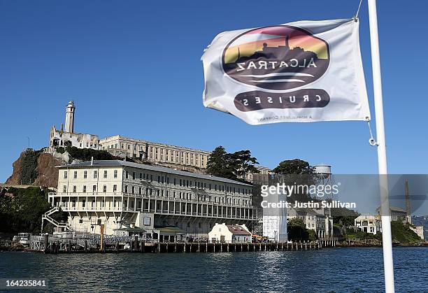 Flag flies on a ferry as it approcahes Alcatraz Island on March 21, 2013 in San Francisco, California. The National Park Service marked the 50th...