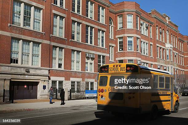 School bus drives by the Jean De Lafayette Elementary School on March 21, 2013 in Chicago, Illinois. The school is one of 50 schools slated to be...