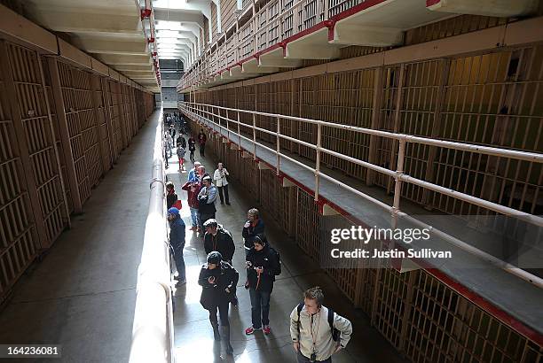 Tourists walk through the main cell block at Alcatraz Island on March 21, 2013 in San Francisco, California. The National Park Service marked the...