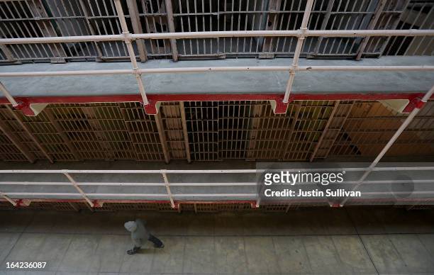 Tourist walks through the main cell block at Alcatraz Island on March 21, 2013 in San Francisco, California. The National Park Service marked the...