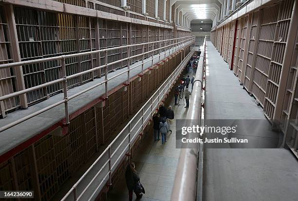 Tourists walk through the main cell block at Alcatraz Island on March 21, 2013 in San Francisco, California. The National Park Service marked the...