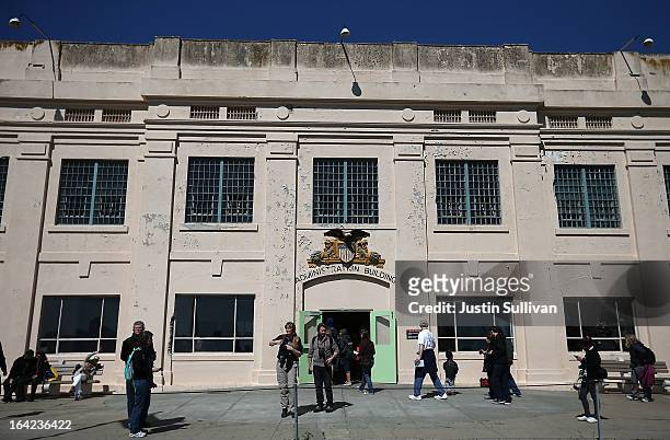 Tourists walk by the administration building at Alcatraz Island on March 21, 2013 in San Francisco, California. The National Park Service marked the...