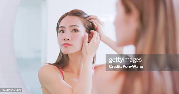 la mujer se preocupa por la pérdida de cabello - cuero cabelludo fotografías e imágenes de stock