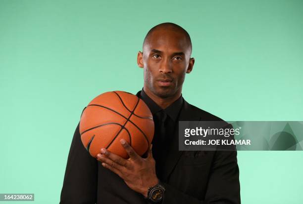 Los Angeles Laker Kobe Bryant poses for pictures as he attends the celebration of Hublot's new brand ambassador Kobe Bryant on March 20, 2013 in Los...