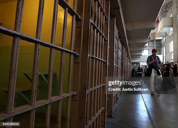 Tourists walk through the main cell block at Alcatraz Island on March 21, 2013 in San Francisco, California. The National Park Service marked the...