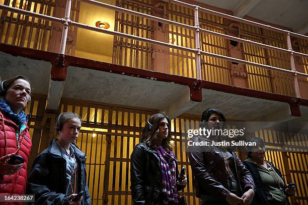 Tourists do an audio tour of the main cell block at Alcatraz Island on March 21, 2013 in San Francisco, California. The National Park Service marked...