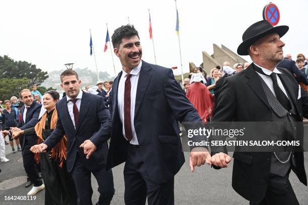 Chilean national rugby team players dance with traditional Breton dancers during the team's welcoming ceremony at the convention centre in...